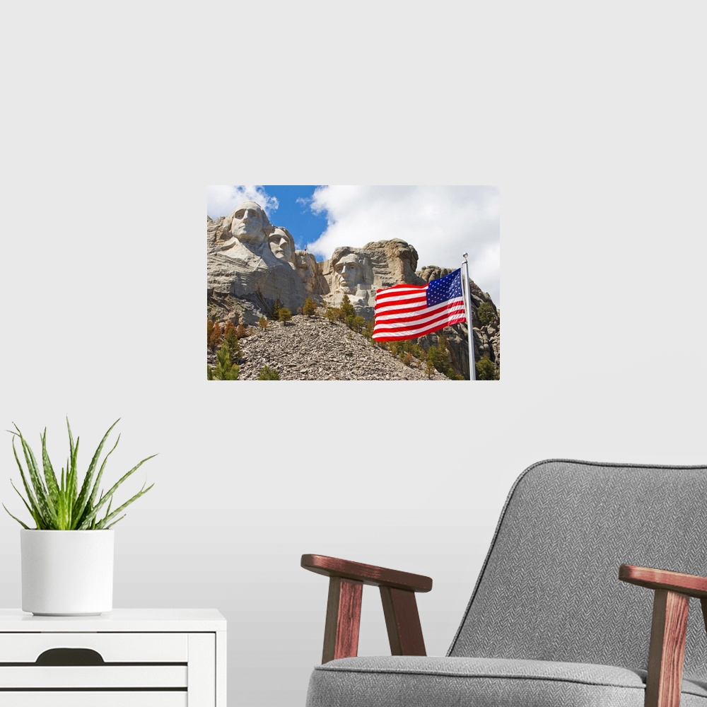 A modern room featuring The United States flag proudly flying in front of Mount Rushmore.