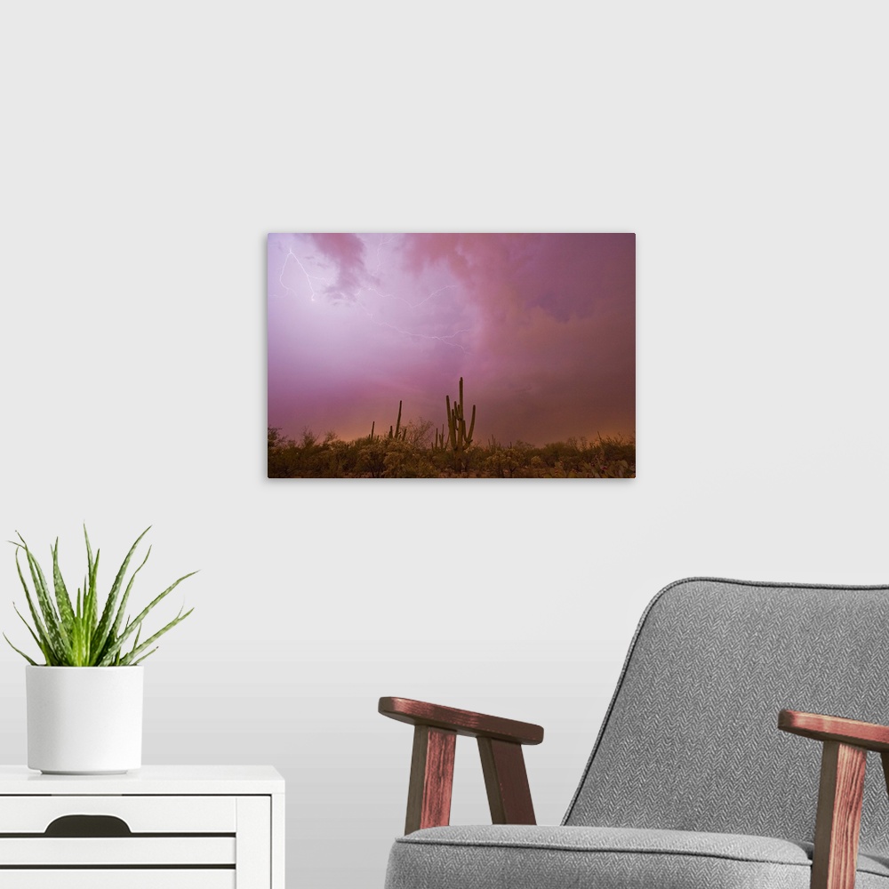 A modern room featuring Lightning brightens the sky over the desert during a thunderstorm.