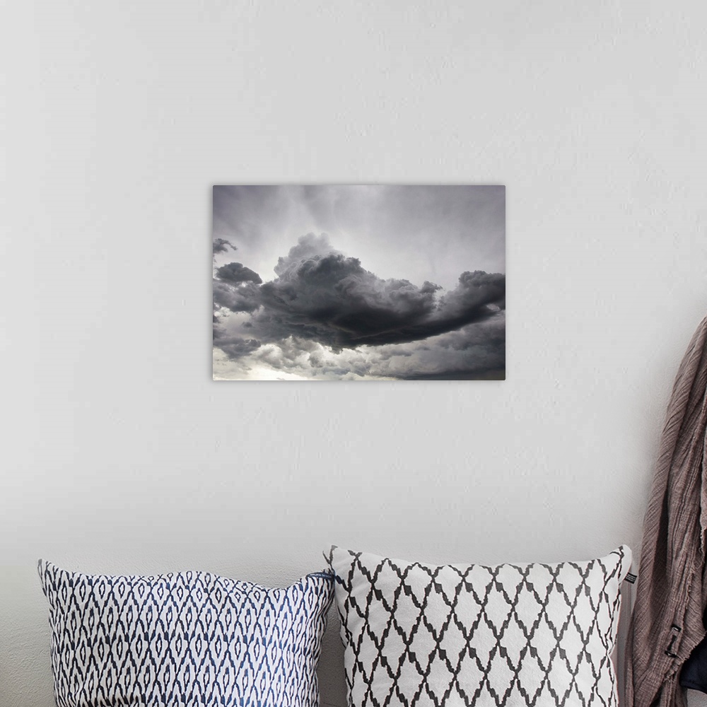 A bohemian room featuring Underneath a supercell thunderstorm with dark and eerie storm clouds.