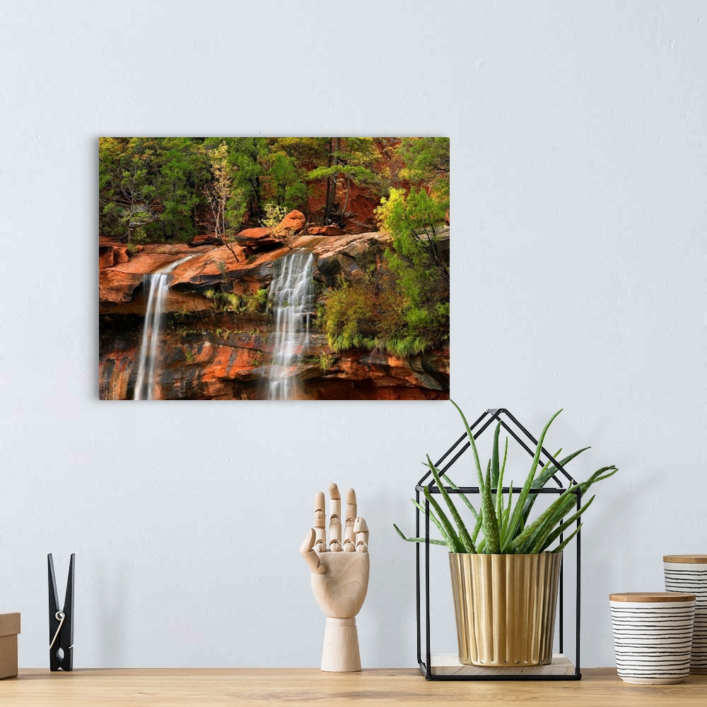 A bohemian room featuring Big canvas print of two waterfalls trickling down a rocky cliff in Utah.