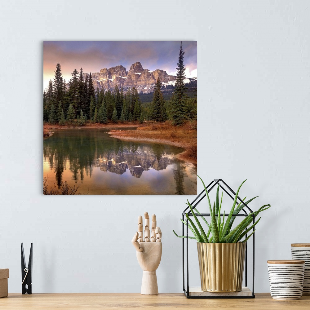 A bohemian room featuring Castle Mountain and boreal forest reflected in lake, Banff National Park, Alberta
