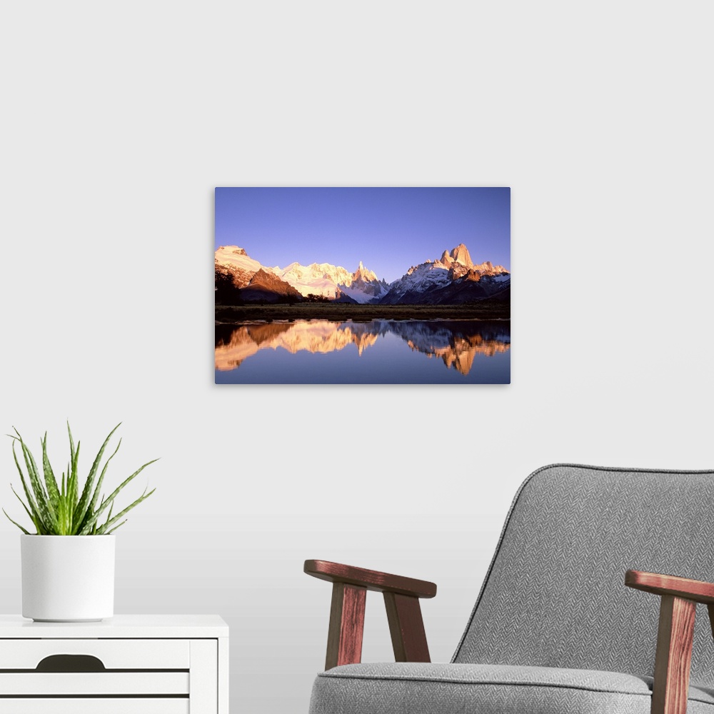A modern room featuring Cerro Torre, centre, and Mount FitzRoy, right, Cerro Solo, left, at dawn famous peaks on edge of ...