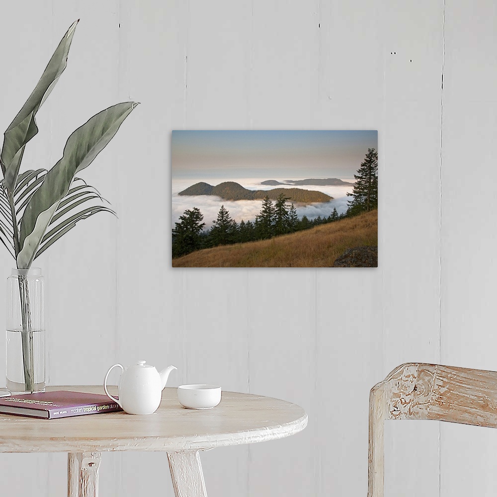A farmhouse room featuring Entrance Mountain and Mount Woolard emerge from sea fog around Orcas Island as seen from Mt. Cons...
