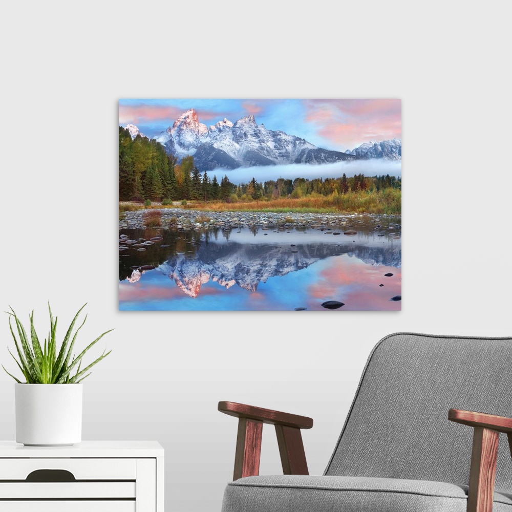 A modern room featuring Giant photograph incorporates a large mountain range covered in snow reflecting over a calm body ...