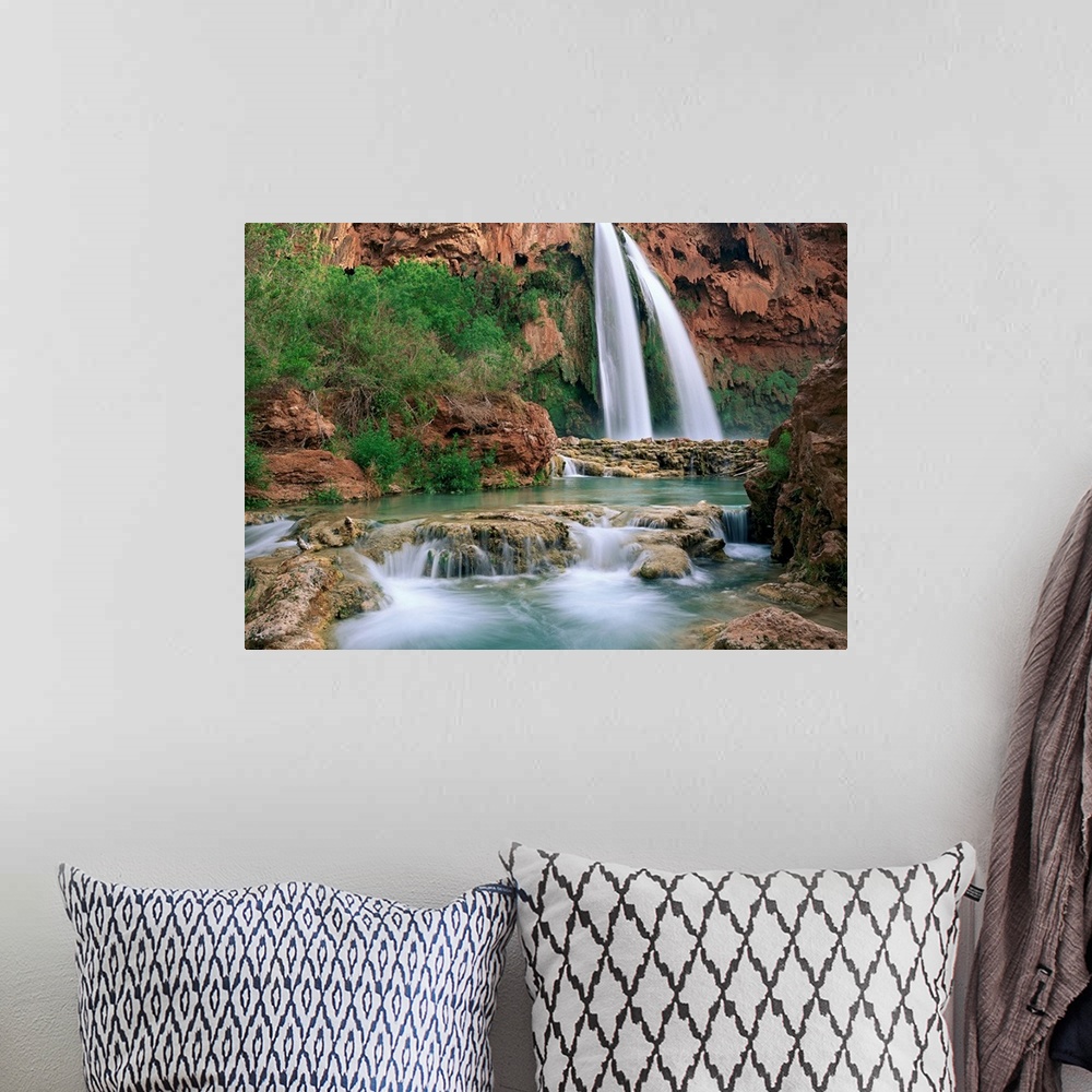 A bohemian room featuring Time lapsed photograph of a waterfall and creek lined with cottonwood trees in a gorge carved by ...