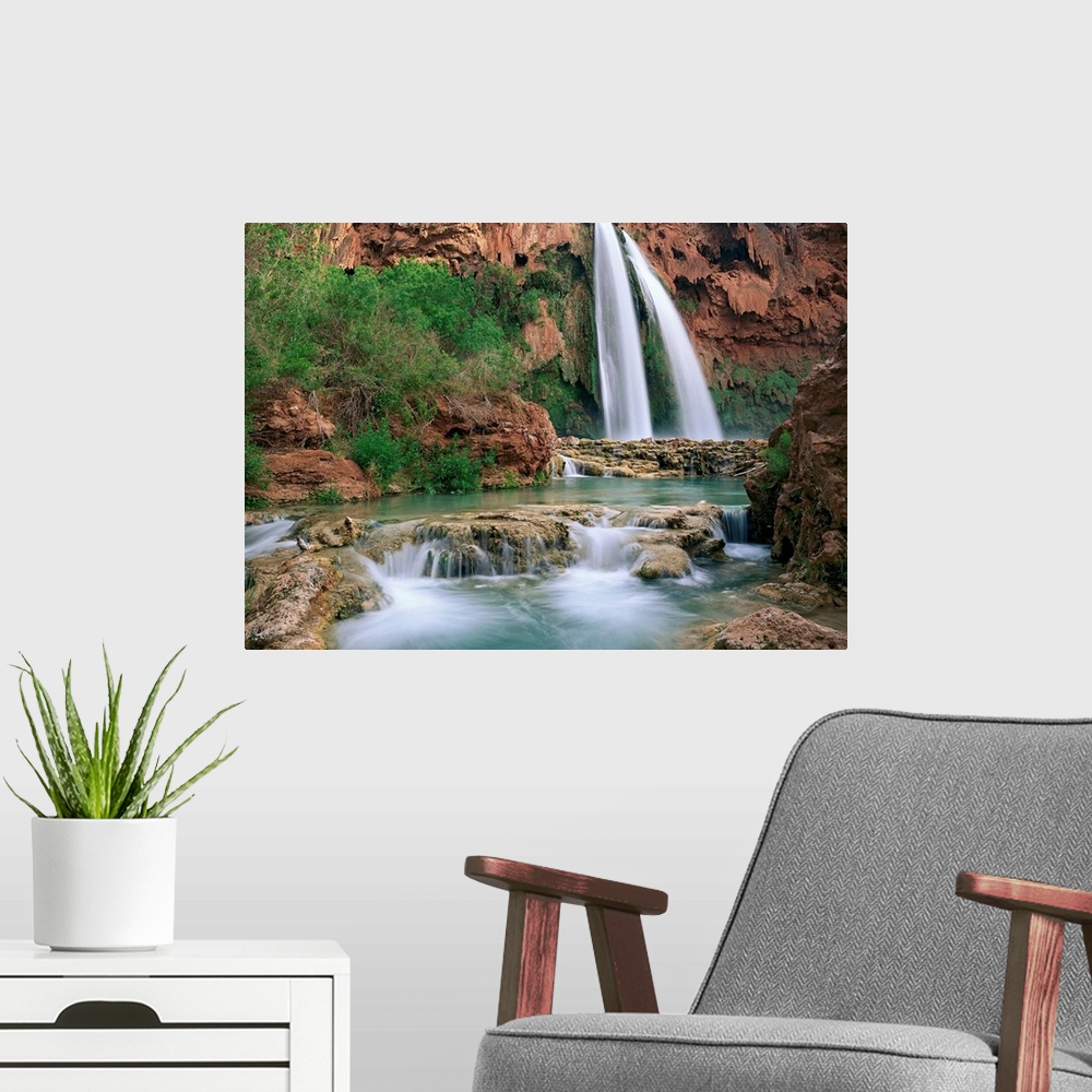 A modern room featuring Time lapsed photograph of a waterfall and creek lined with cottonwood trees in a gorge carved by ...