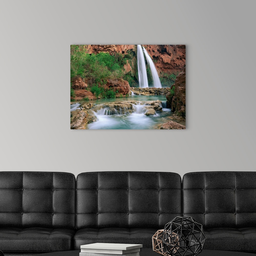 A modern room featuring Time lapsed photograph of a waterfall and creek lined with cottonwood trees in a gorge carved by ...