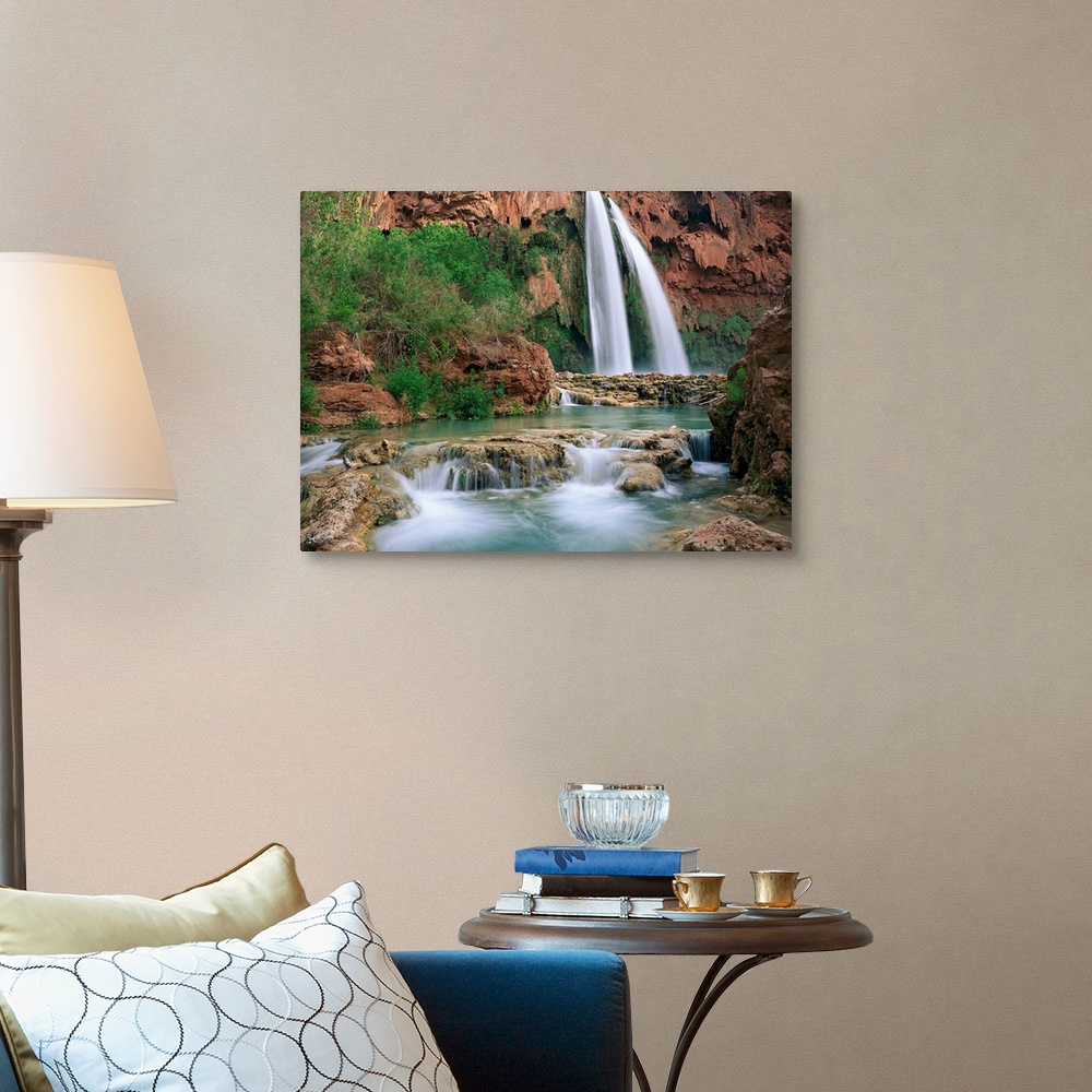 A traditional room featuring Time lapsed photograph of a waterfall and creek lined with cottonwood trees in a gorge carved by ...