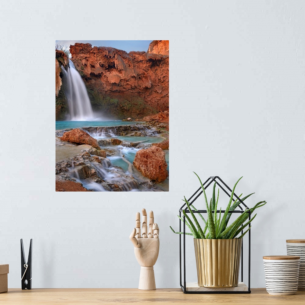 A bohemian room featuring Large photograph showcases water falling down a jagged cliff and splashing into the pool below be...