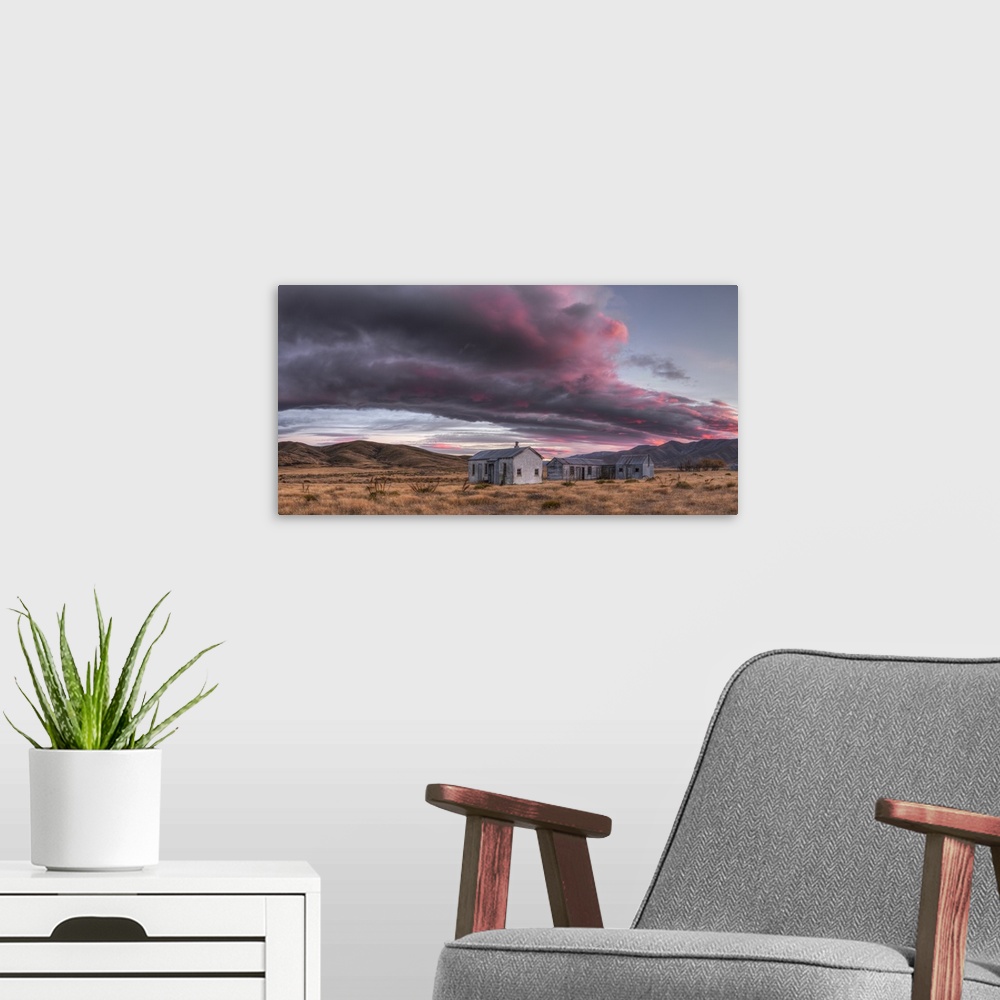 A modern room featuring Dawn lights up cloudscape over historic (1939) farm buildings, panorama near St Bathans, Central ...