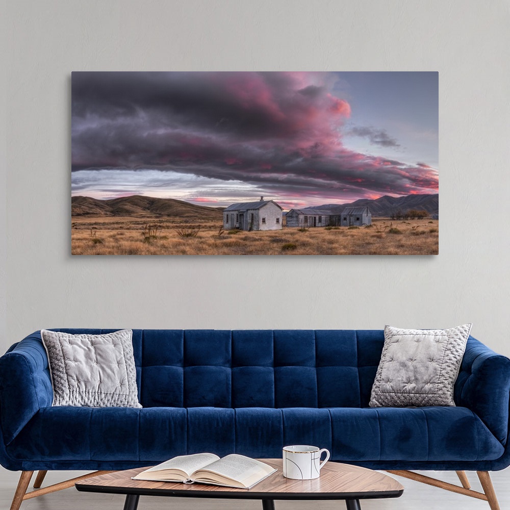 A modern room featuring Dawn lights up cloudscape over historic (1939) farm buildings, panorama near St Bathans, Central ...