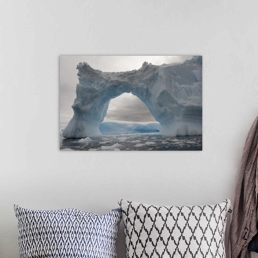 A bohemian room featuring Iceberg with a natural arch, Antarctic Peninsula, Antarctica