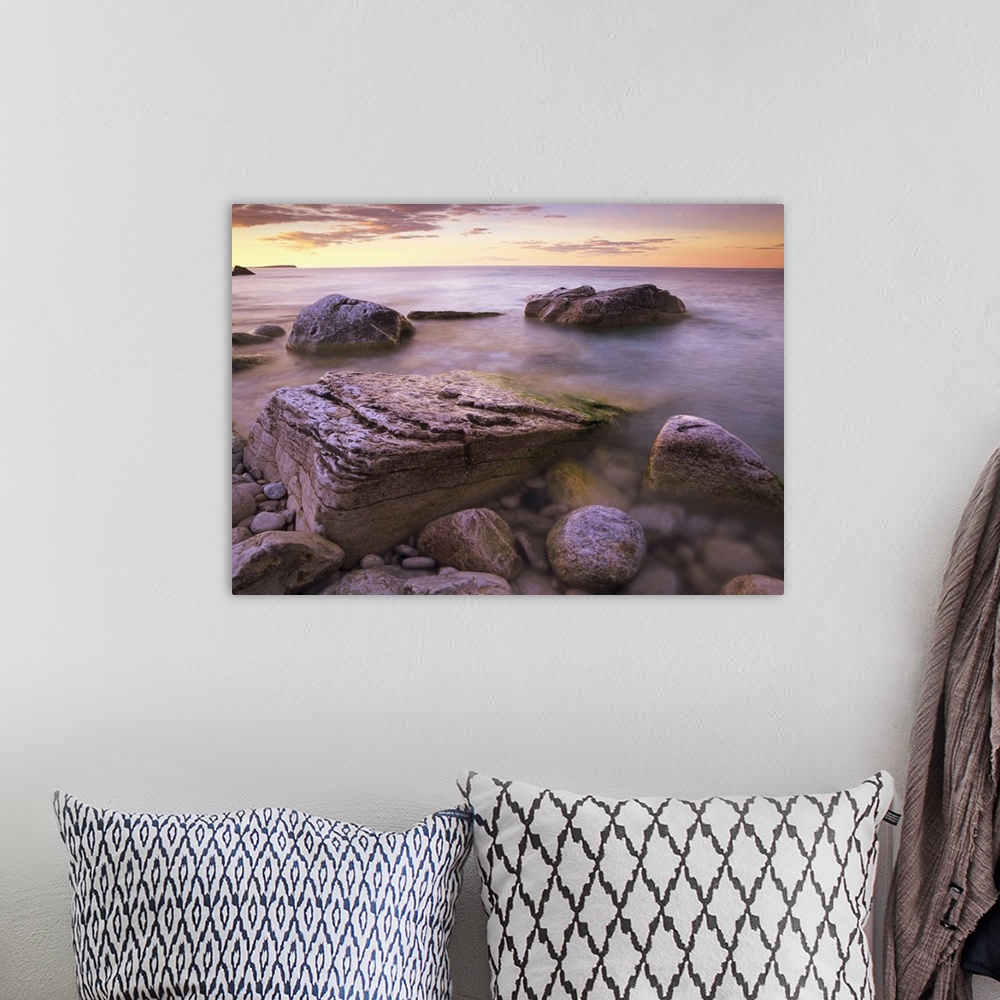 A bohemian room featuring Photograph of rocky shoreline filled with large boulders under a cloudy sky.