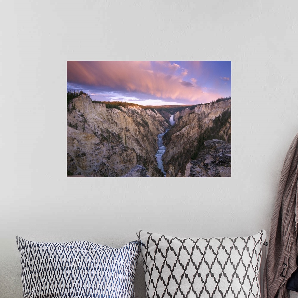 A bohemian room featuring Lower Yellowstone Falls running through a valley in Yellowstone National Park with the sunset hit...