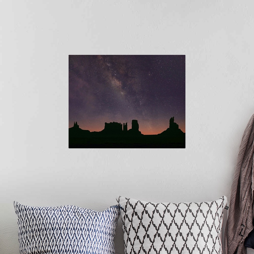 A bohemian room featuring Milky Way and starry sky over buttes, Monument Valley, Arizona