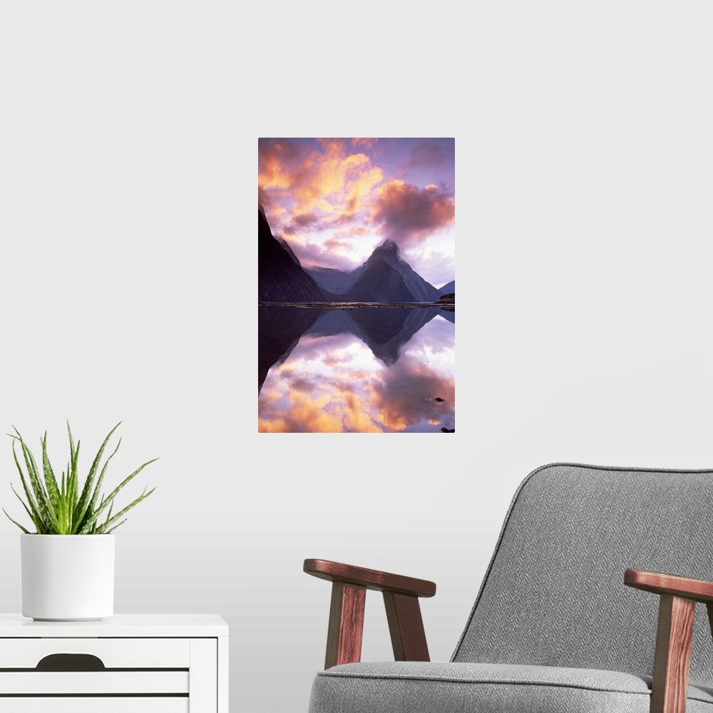 A modern room featuring Big, vertical photograph of Mitre Peak, reflecting in the still water of Milford Sound, as the su...