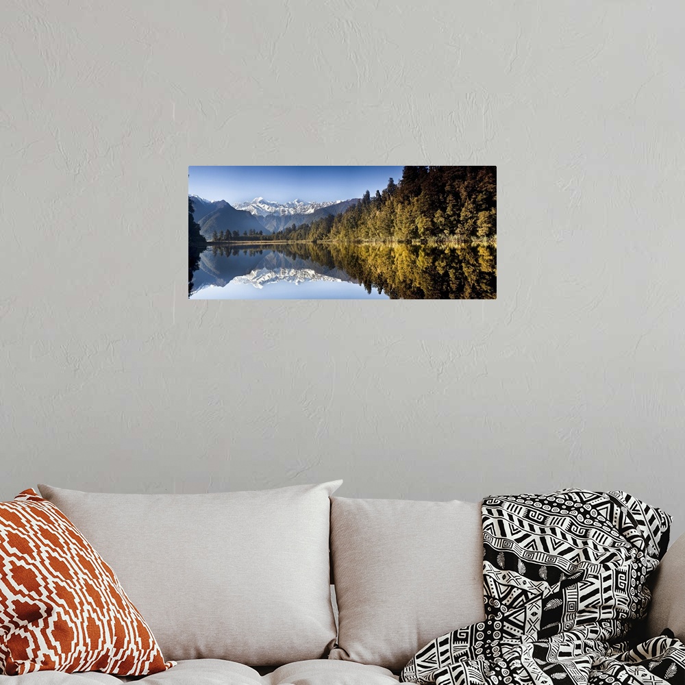 A bohemian room featuring Mount Cook and Mount Tasman reflected in Lake Matheson at sunset near Fox Glacier, New Zealand