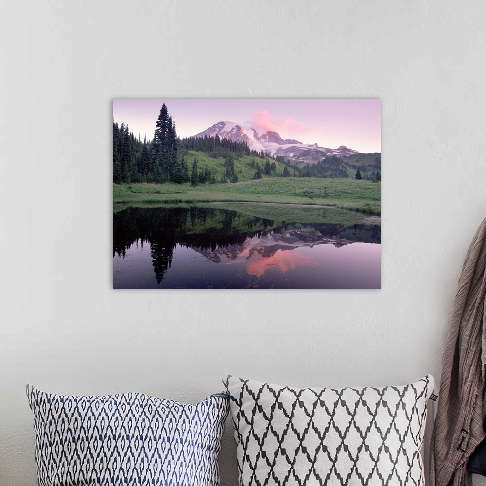 A bohemian room featuring Photograph of snow covered mountain and tree covered hills reflected in water below.