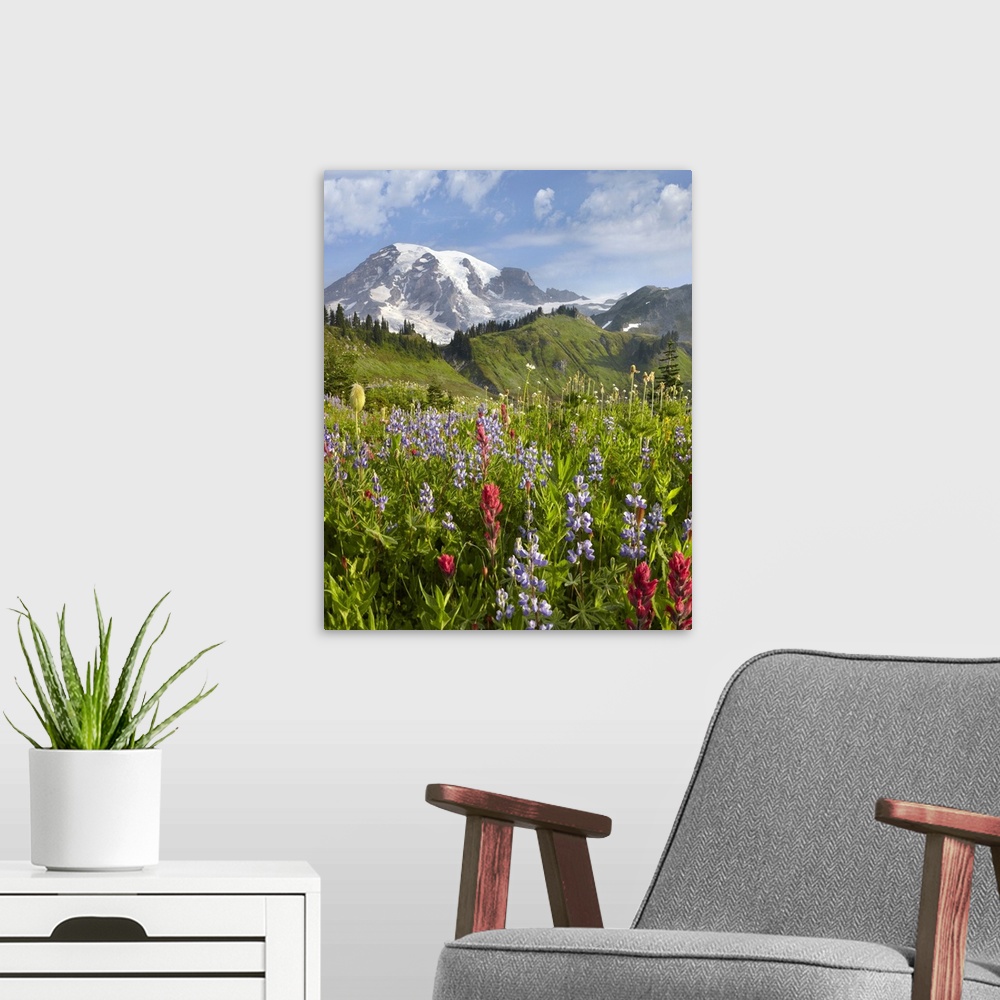 A modern room featuring A vertical photograph of a nature landscape filled with wildflowers in the foreground, trees grow...