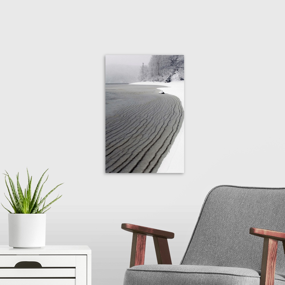 A modern room featuring pleated ice along beach in winter Nova Scotia