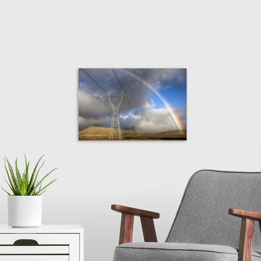 A modern room featuring Powerlines, rainbow forms as evening sun lights up rain clouds, Canterbury, New Zealand