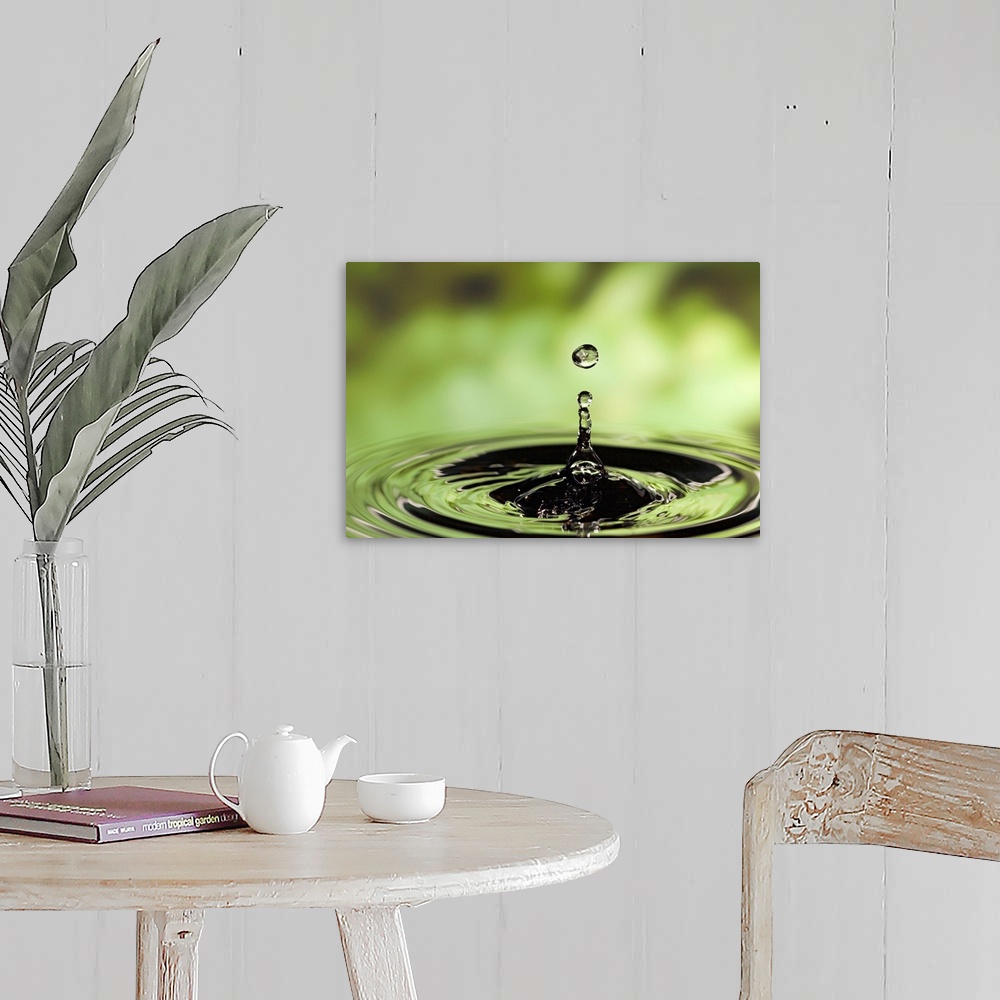 A farmhouse room featuring Horizontal photograph of drop of water frozen in the air and rippling in the surface below.