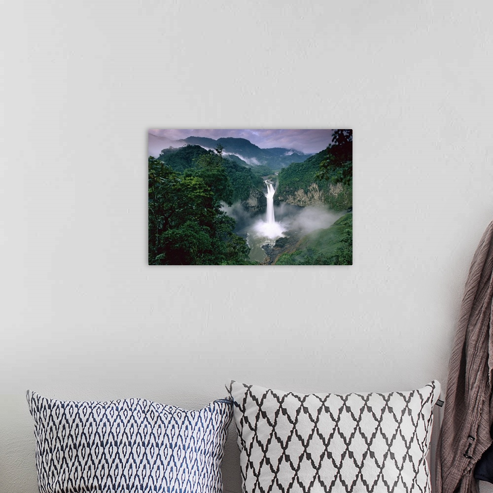 A bohemian room featuring Photograph of waterfall surrounded by rainforest with mountain silhouette in the distance.