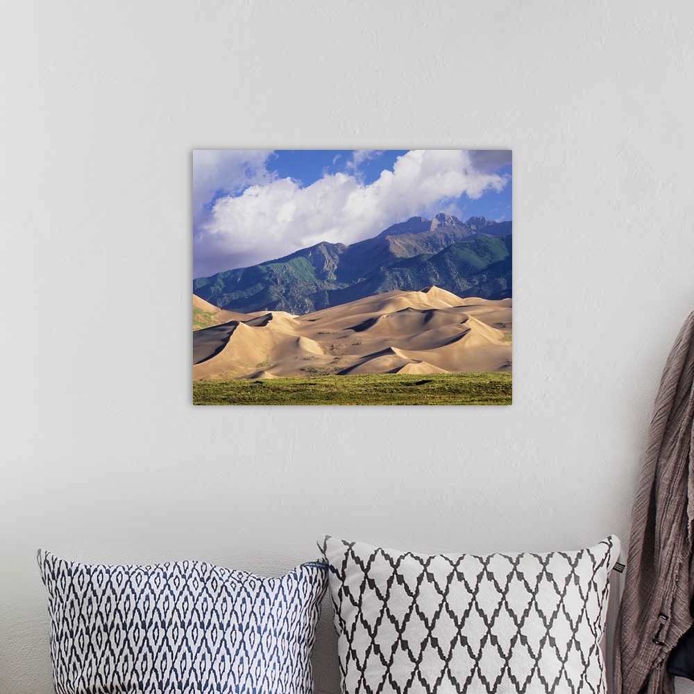 A bohemian room featuring Sand dunes with Sangre de Cristo Mountains in the background, Colorado