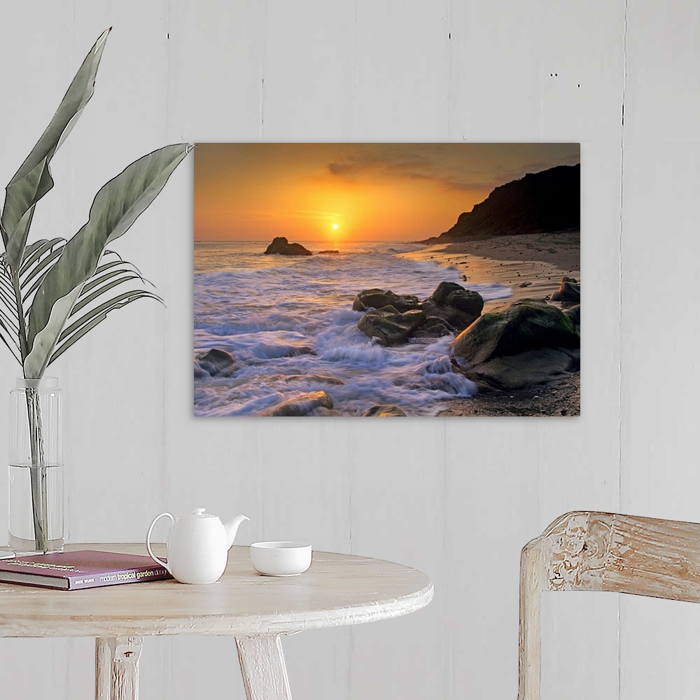 A farmhouse room featuring Large landscape photograph of a golden sunset over the rocky shoreline at Leo Carrillo State Beac...