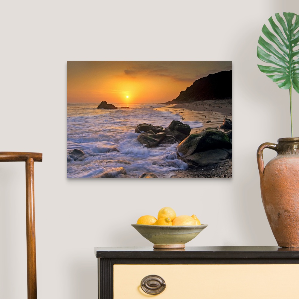 A traditional room featuring Large landscape photograph of a golden sunset over the rocky shoreline at Leo Carrillo State Beac...
