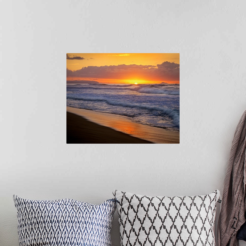 A bohemian room featuring The sunset dips below the ocean horizon as ocean swells dash against the sandy tropical shoreline.