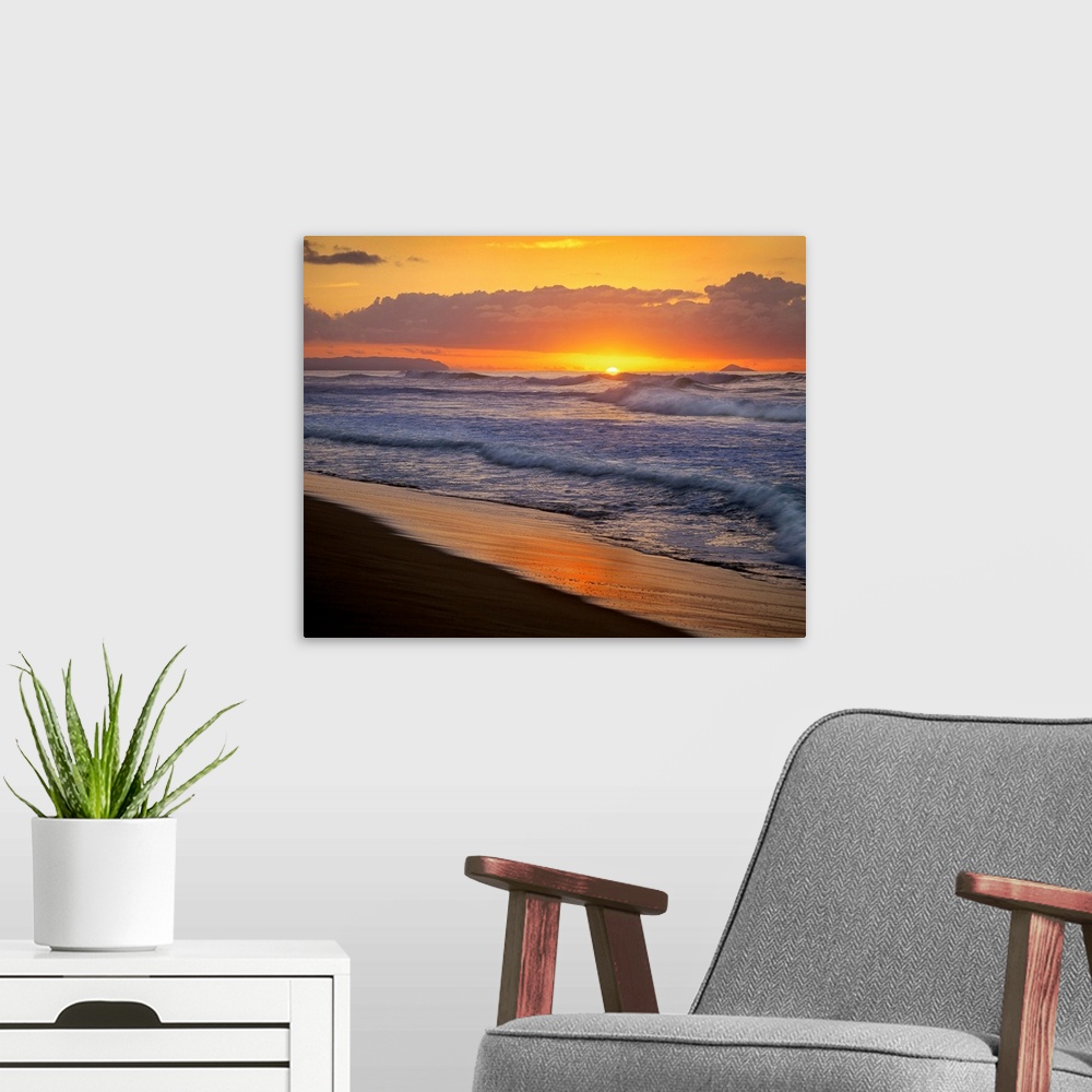 A modern room featuring The sunset dips below the ocean horizon as ocean swells dash against the sandy tropical shoreline.