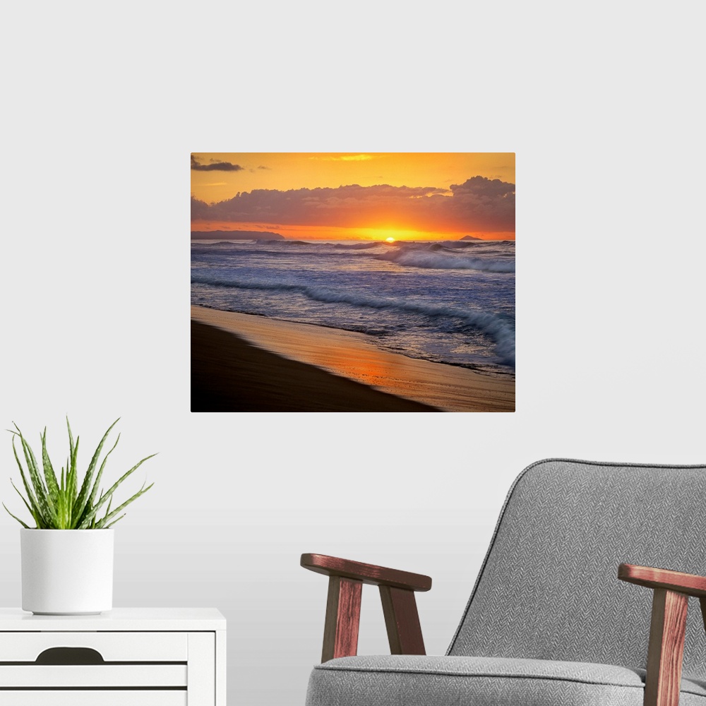 A modern room featuring The sunset dips below the ocean horizon as ocean swells dash against the sandy tropical shoreline.