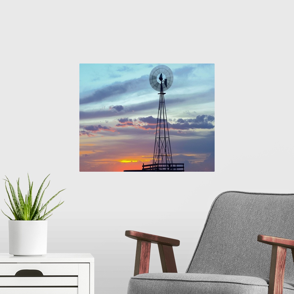 A modern room featuring Windmill producing electricity at sunset example of renewable energy, North America