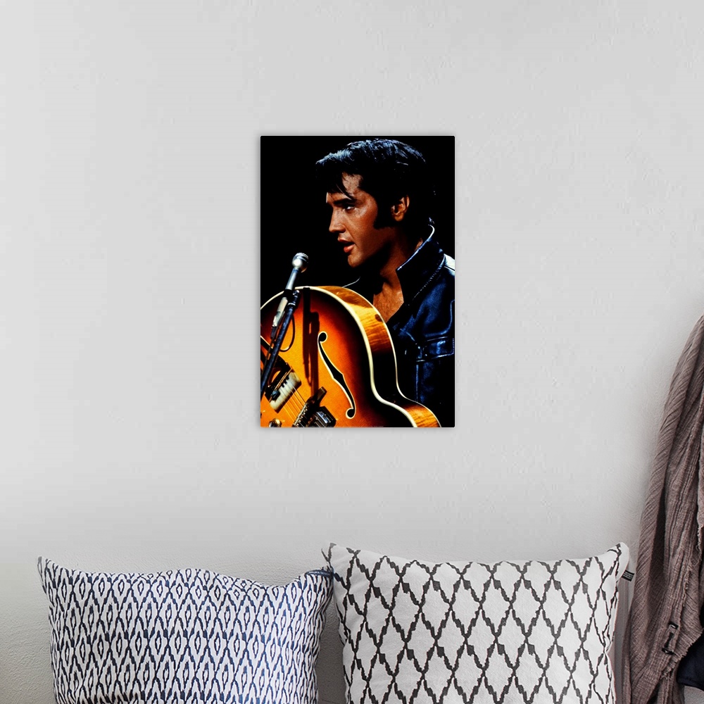 A bohemian room featuring Big canvas photo of an up close shot of Elvis Presley holding a guitar in front of a microphone.
