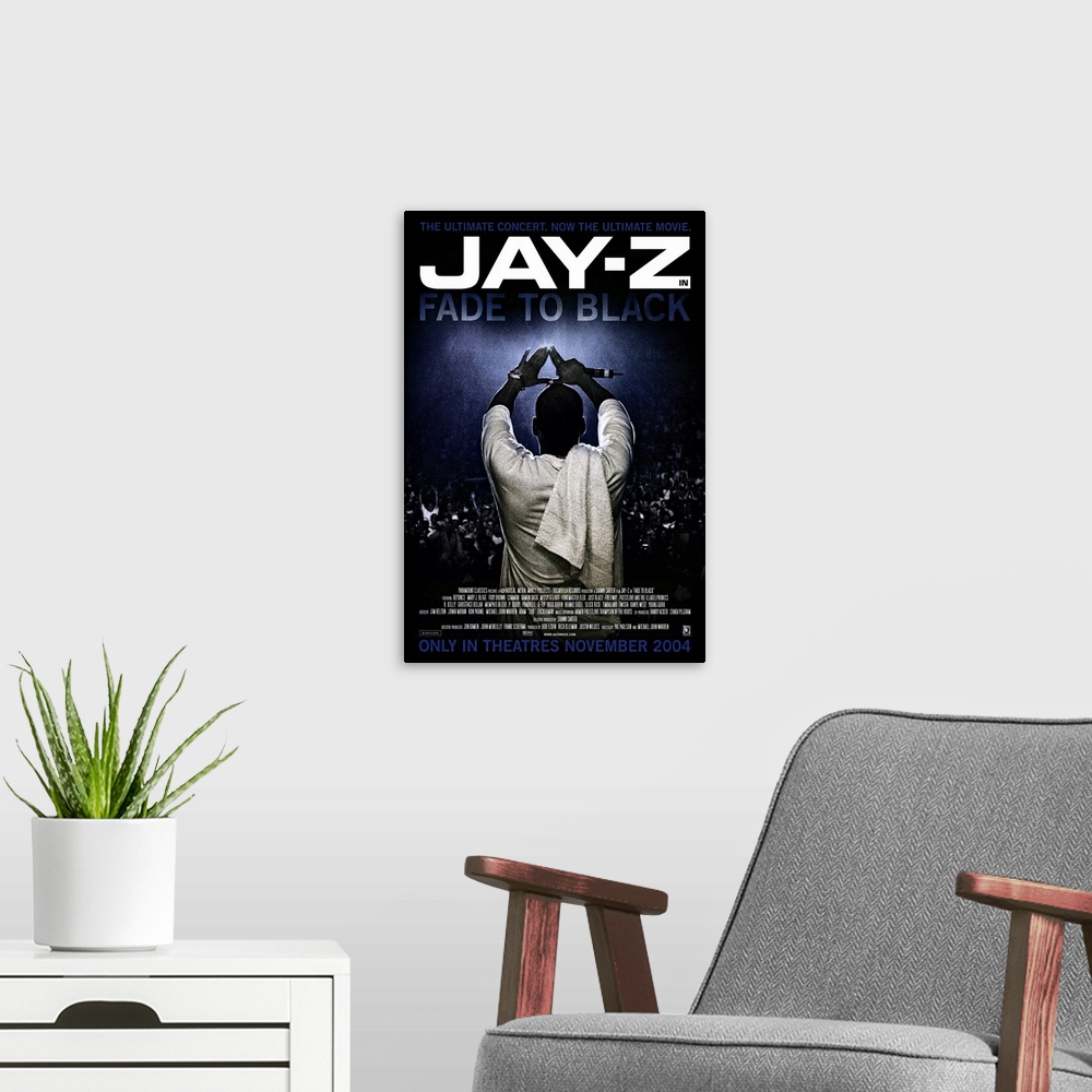 A modern room featuring Vertical movie advertisement for the 2004 film, Fade to Black, starring Jay-Z.  Jay-Z stands faci...