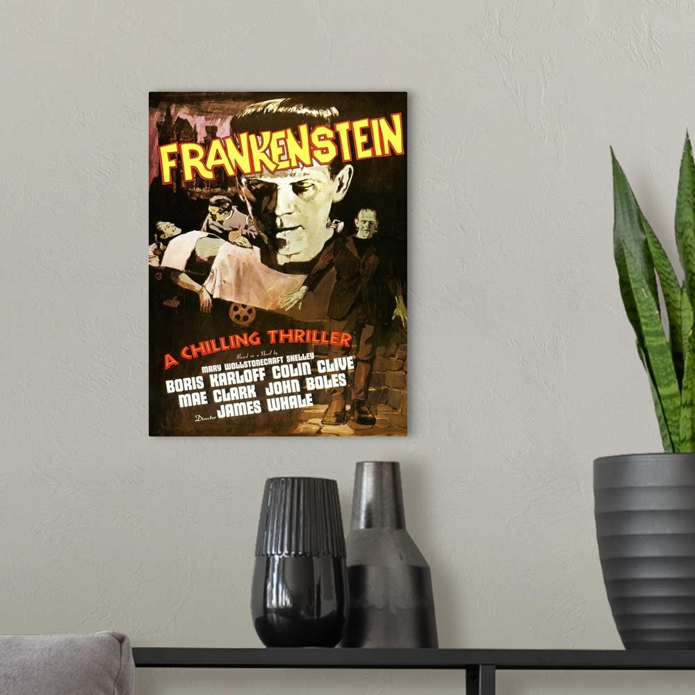A modern room featuring Movie poster for the classic movie "Frankenstein". It shows a close up of only his head, him lyin...