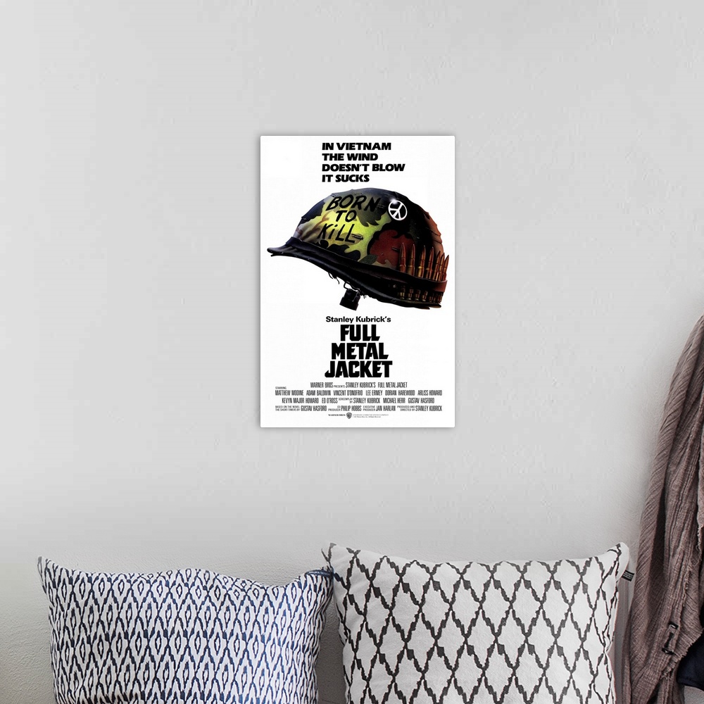 A bohemian room featuring Poster for the hit movie "Full Metal Jacket". A military helmet is pictured with a peace sign on ...