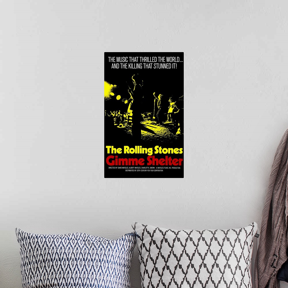 A bohemian room featuring Vintage poster advertising The Rolling Stones "Gimme Shelter" tour with silhouetted picture of th...