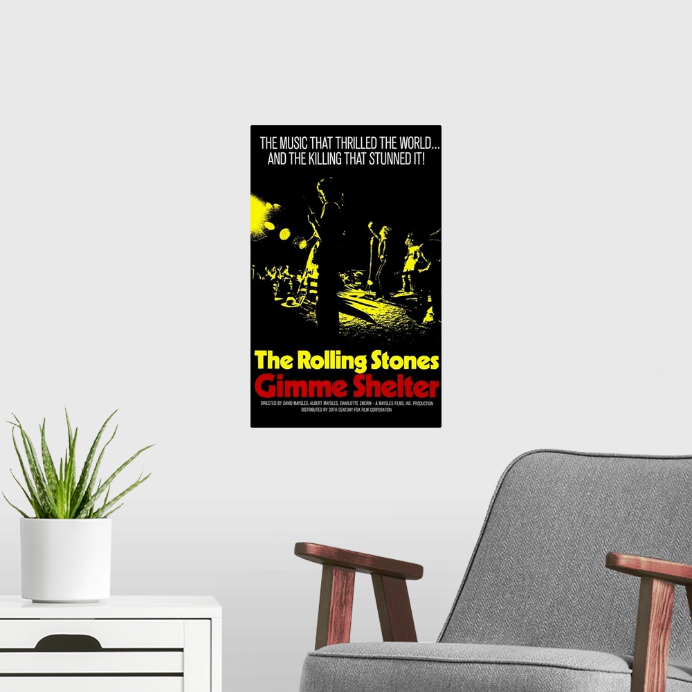 A modern room featuring Vintage poster advertising The Rolling Stones "Gimme Shelter" tour with silhouetted picture of th...