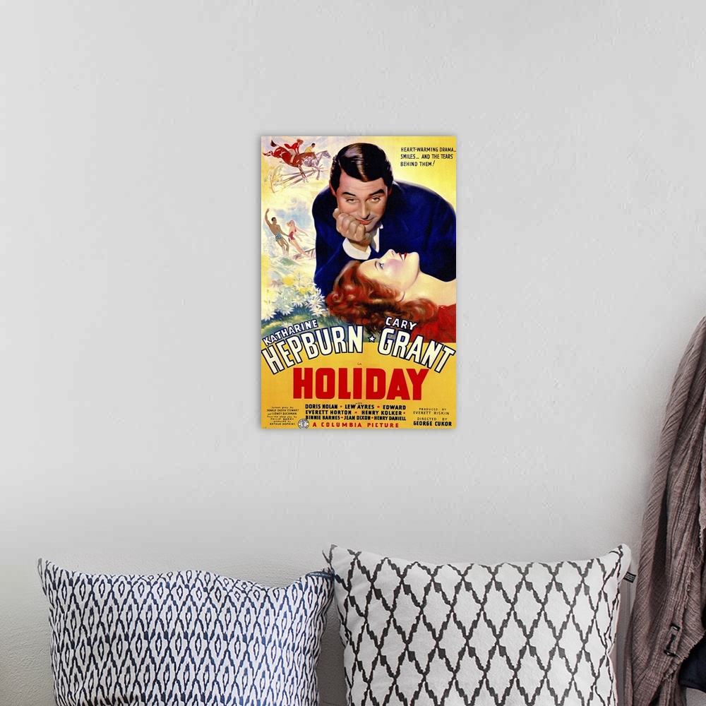 A bohemian room featuring Poster for the classic movie "Holiday" debuting in 1938. It shows the female lead laying her head...