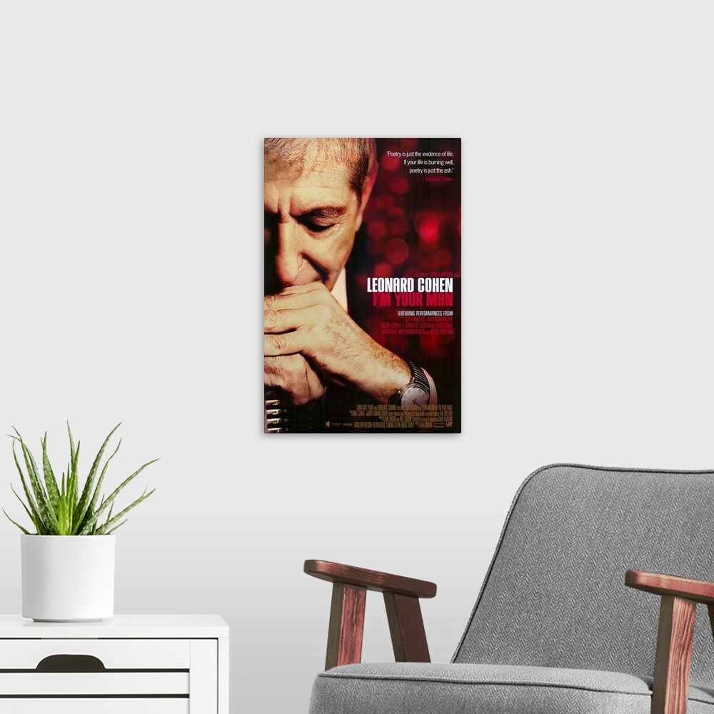A modern room featuring Poster for the movie titled "Leonard Cohen I'm Your Man". It shows a man with both his hands fold...