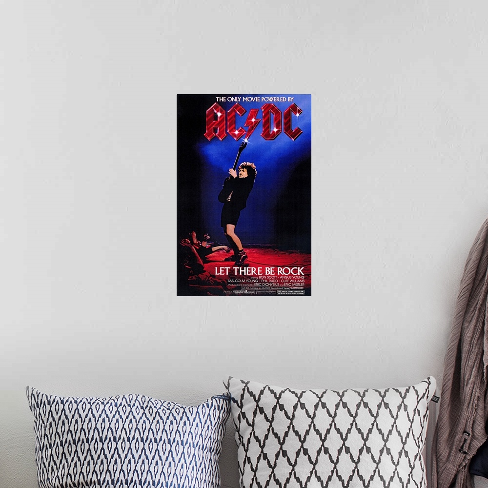 A bohemian room featuring Poster for the movie titled "Let There Be Rock". It shows a guitar player at the edge of the stag...