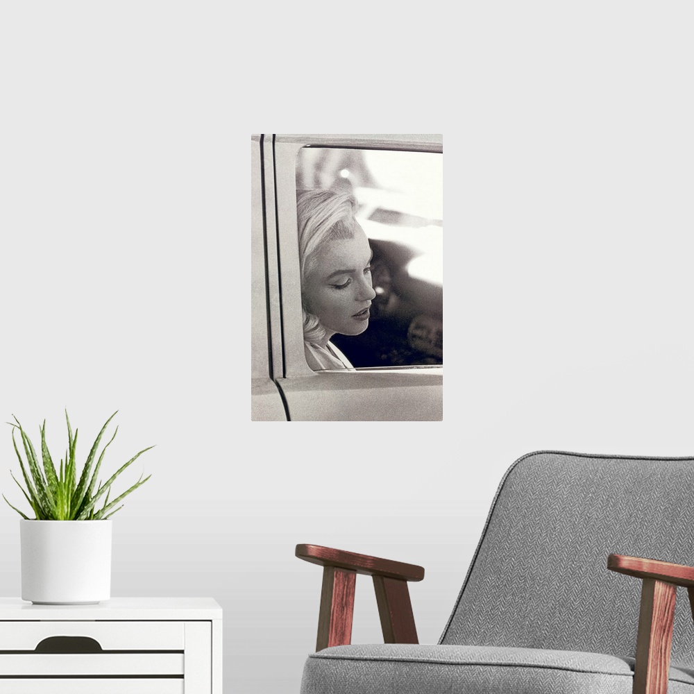 A modern room featuring Vintage photo of the popular celebrity resting her head against the window of a car door, her eye...