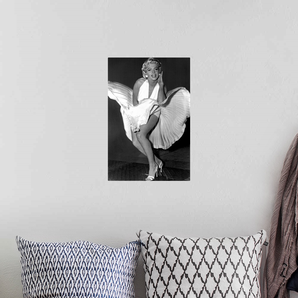 A bohemian room featuring A vertical photograph of the actress in her white dress and high heels standing over a subway gra...