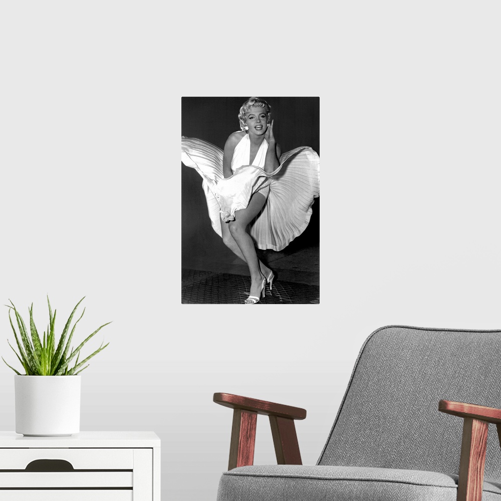 A modern room featuring A vertical photograph of the actress in her white dress and high heels standing over a subway gra...