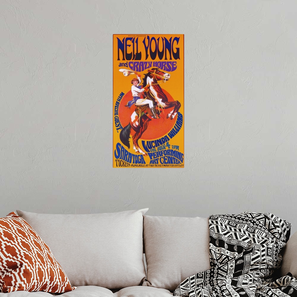 A bohemian room featuring Movie poster for "Neil Young and Crazy Horse" with a horse standing on its back legs as a cowboy ...