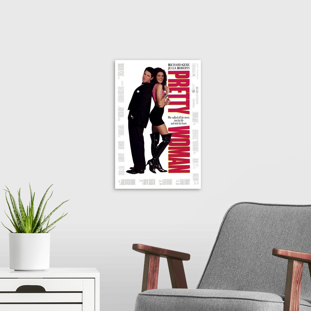 A modern room featuring Vertical, large movie advertisement for "Pretty Woman", with Julia Roberts and Richard Gere stand...