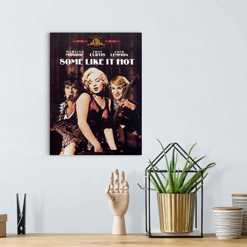 A bohemian room featuring Big, vertical movie advertisement for Some Like it Hot, the three stars, Marilyn Monroe, Tony Cur...