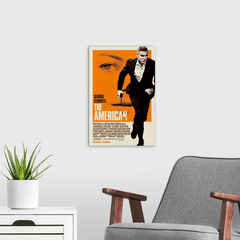 A modern room featuring The American - Movie Poster